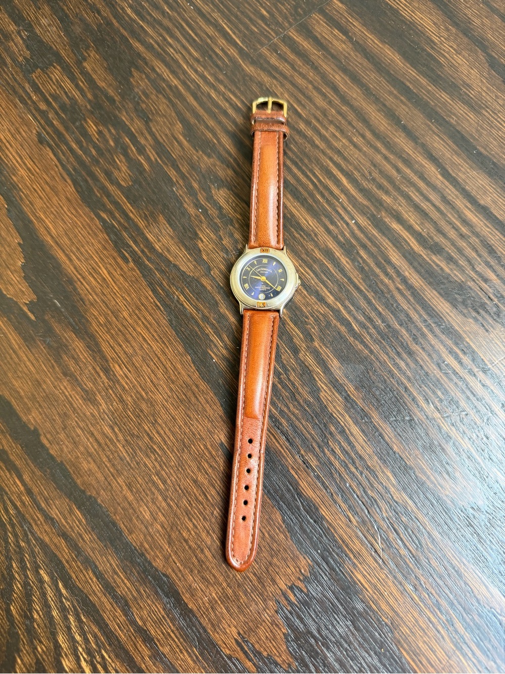 Vintage Levi’s quartz watch with a dark blue dial and a brown leather strap.